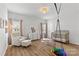 Well-lit Bedroom with wood floors, chair with ottoman, stylish lighting and modern decorations at 7025 Amberhouse Dr, Charlotte, NC 28212