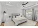 Spacious main bedroom with tray ceiling, ceiling fan, and bright natural light at 7025 Amberhouse Dr, Charlotte, NC 28212