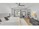 A brightly lit main bedroom showcases neutral decor, tray ceilings, and wood flooring at 7025 Amberhouse Dr, Charlotte, NC 28212