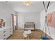 Well-lit Bedroom with wood floors, modern crib, stylish lighting and modern decorations at 7025 Amberhouse Dr, Charlotte, NC 28212