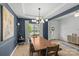 Dining room featuring dark accent walls, stylish decor, and ample natural light at 7025 Amberhouse Dr, Charlotte, NC 28212
