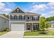 Charming two-story home with gray siding, black shutters, and a well-manicured front lawn at 7025 Amberhouse Dr, Charlotte, NC 28212