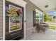 Close-up of a welcoming front door with a decorative wreath and cozy porch seating area at 7025 Amberhouse Dr, Charlotte, NC 28212