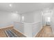 Bright hallway features hardwood floors, white walls, with view to open concept living room at 7025 Amberhouse Dr, Charlotte, NC 28212