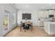 Eat-in kitchen with light cabinets, modern appliances, and direct access to the outdoor living space at 7025 Amberhouse Dr, Charlotte, NC 28212