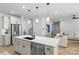 Open kitchen features a large island with a stainless dishwasher and views of the staircase at 7025 Amberhouse Dr, Charlotte, NC 28212