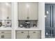 Built-in coffee bar with stainless steel appliances, decorative hardware, and stylish marble backsplash at 7025 Amberhouse Dr, Charlotte, NC 28212