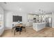 Bright kitchen features an island, stainless appliances, and adjacent breakfast nook with stylish decor at 7025 Amberhouse Dr, Charlotte, NC 28212