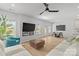 Spacious living room with a cozy fireplace, open floor plan, and direct access to outdoor amenities at 7025 Amberhouse Dr, Charlotte, NC 28212