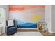 Inviting living room with colorful mural, accent chair, and hardwood floors at 7025 Amberhouse Dr, Charlotte, NC 28212