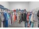 Spacious walk-in closet featuring ample storage with metal shelving and racks for clothing and accessories at 7025 Amberhouse Dr, Charlotte, NC 28212