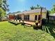 Backyard with a deck and a large grassy area for outdoor activities at 7215 Wingstone Ln, Charlotte, NC 28262