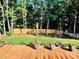 Backyard wooden deck overlooking the beautiful manicured lawn and greenery at 7215 Wingstone Ln, Charlotte, NC 28262