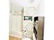 A full bathroom with a floral accent wall, shower, toilet and storage shelves at 7215 Wingstone Ln, Charlotte, NC 28262