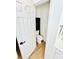 A half bathroom with hardwood floors, a white toilet, and a black storage unit at 7215 Wingstone Ln, Charlotte, NC 28262