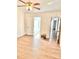 Spacious bedroom featuring hardwood floors, ceiling fan, and an ensuite bathroom at 7215 Wingstone Ln, Charlotte, NC 28262