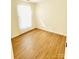 Bright bedroom with wood flooring, white walls, and a bright window at 7215 Wingstone Ln, Charlotte, NC 28262