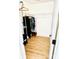 Walk-in closet with wood floor, white wire shelving, and rod filled with clothes at 7215 Wingstone Ln, Charlotte, NC 28262