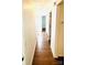 Hallway with wood floors and neutral walls, offering a view into other rooms at 7215 Wingstone Ln, Charlotte, NC 28262