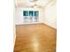 Spacious living room filled with natural light, featuring hardwood floors and neutral walls at 7215 Wingstone Ln, Charlotte, NC 28262