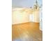 Bright and spacious open-concept living area with hardwood flooring and elegant lighting at 7215 Wingstone Ln, Charlotte, NC 28262