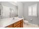 Bathroom featuring a white vanity, a large mirror, toilet, and a window with white shutters at 7731 Sedgebrook E Dr, Stanley, NC 28164