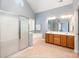 Well-lit bathroom boasts a double sink vanity, soaking tub, and glass shower at 7731 Sedgebrook E Dr, Stanley, NC 28164