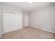 Neutral bedroom featuring wall-to-wall carpeting and closet with sliding doors at 7731 Sedgebrook E Dr, Stanley, NC 28164