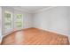 Cozy bedroom with wood floors and bright window creating a warm and inviting space at 7731 Sedgebrook E Dr, Stanley, NC 28164