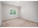 This carpeted bedroom has a window providing natural light at 7731 Sedgebrook E Dr, Stanley, NC 28164