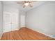 Bedroom with wood floors, neutral walls, a ceiling fan, and a double closet at 7731 Sedgebrook E Dr, Stanley, NC 28164