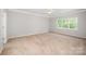 Spacious bedroom features neutral carpet, ample natural light, and a ceiling fan at 7731 Sedgebrook E Dr, Stanley, NC 28164