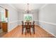 Dining room with wood floors, classic chandelier and a window offering a view at 7731 Sedgebrook E Dr, Stanley, NC 28164