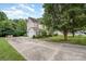 Two-story home with a two-car garage and long driveway, surrounded by trees at 7731 Sedgebrook E Dr, Stanley, NC 28164