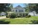 Charming two-story home with a well-manicured lawn and inviting front porch at 7731 Sedgebrook E Dr, Stanley, NC 28164