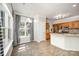 Eat-in kitchen with stainless steel appliances, a breakfast bar, and a bright window with patterned curtains at 7731 Sedgebrook E Dr, Stanley, NC 28164