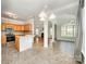 Open floor plan kitchen and breakfast nook with a view of the living room and fireplace at 7731 Sedgebrook E Dr, Stanley, NC 28164