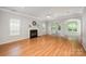 Bright living room with fireplace, hardwood floors, and arched doorways at 7731 Sedgebrook E Dr, Stanley, NC 28164