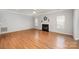 Spacious living room with wood floors and a cozy fireplace, bathed in natural light at 7731 Sedgebrook E Dr, Stanley, NC 28164