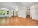 Open living room featuring hardwood floors, arched doorways and ceiling fan at 7731 Sedgebrook E Dr, Stanley, NC 28164
