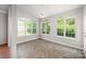 Inviting sunroom with tile flooring, ceiling fan and large windows bringing the outdoors in at 7731 Sedgebrook E Dr, Stanley, NC 28164