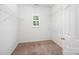 Walk-in closet featuring shelving and a window for natural light at 7731 Sedgebrook E Dr, Stanley, NC 28164