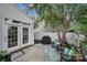 A private back patio with a grill and seating area surrounded by lush greenery and a white fence at 918 Kite Dr, Fort Mill, SC 29715