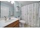 Bathroom features a single sink vanity, patterned shower curtain, and decorative wall art at 918 Kite Dr, Fort Mill, SC 29715