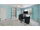 Bedroom featuring gray carpet, blue walls, desk, shelves, fan, and natural light at 918 Kite Dr, Fort Mill, SC 29715