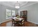 Elegant dining room featuring tray ceilings, wood floors, and large windows at 918 Kite Dr, Fort Mill, SC 29715