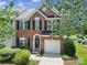 Beautiful brick home featuring black shutters, a well manicured lawn, and an attached one car garage at 918 Kite Dr, Fort Mill, SC 29715