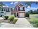 Charming brick-front townhome with well-manicured landscaping and attached garage at 918 Kite Dr, Fort Mill, SC 29715