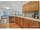 Kitchen with stainless steel appliances, wood cabinets, tile backsplash and an open design to the dining room at 918 Kite Dr, Fort Mill, SC 29715