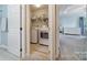 A practical laundry room featuring modern appliances and convenient shelving, leading to a serene bedroom at 918 Kite Dr, Fort Mill, SC 29715